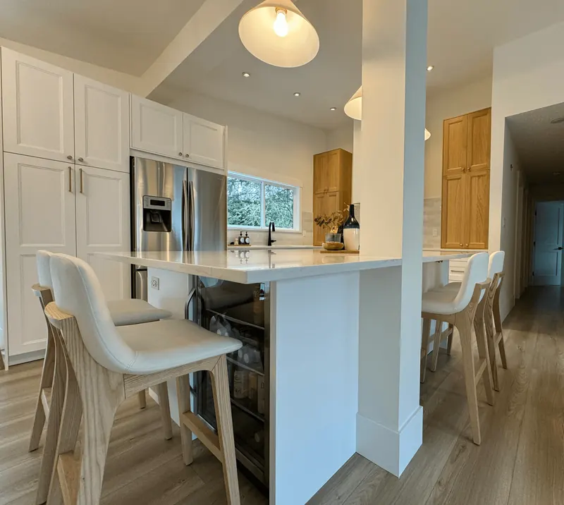 Oversized kitchen island with bar stools and pendant lights