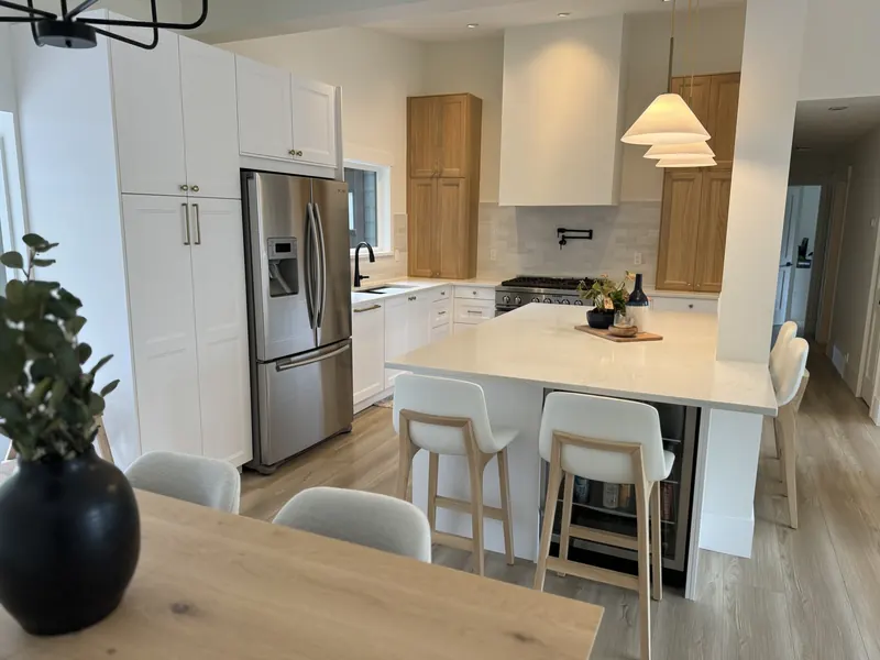 Bright open kitchen with an island and bar seating in Brookswood, Langley