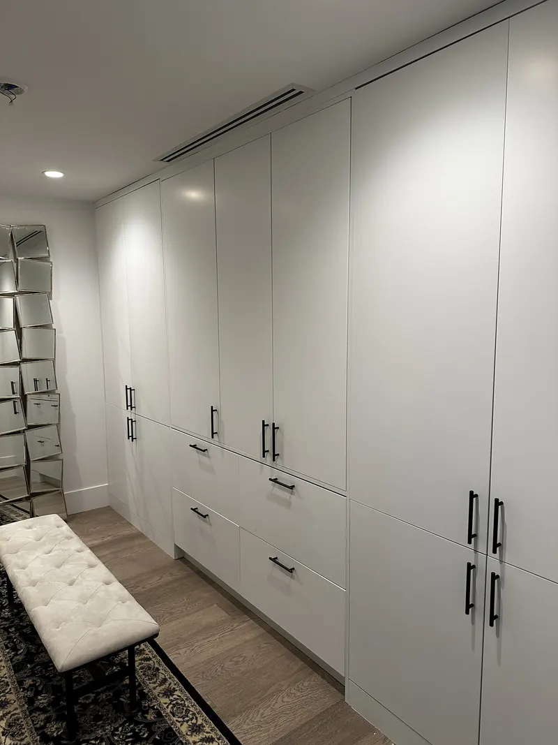 White custom wardrobes with black pulls