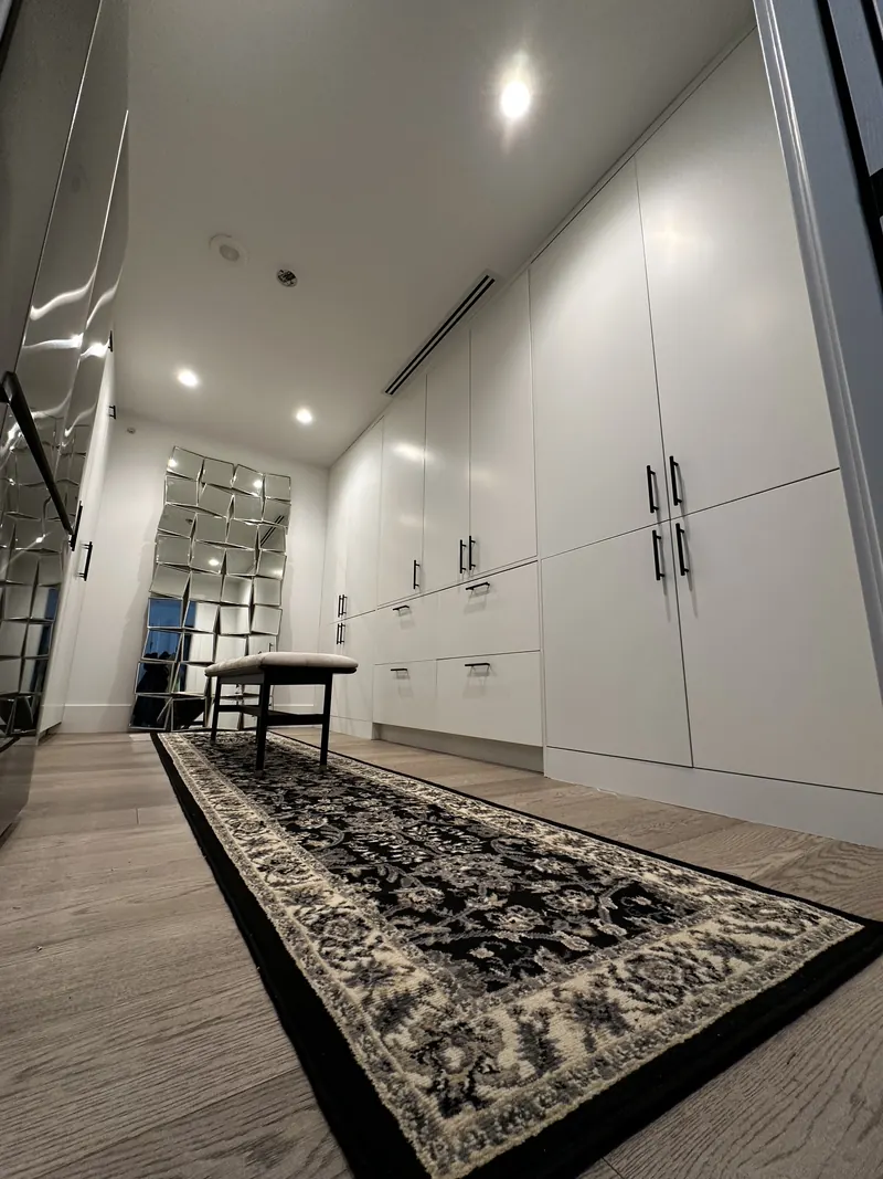 Custom white wardrobes in the Fantom Tower dressing room